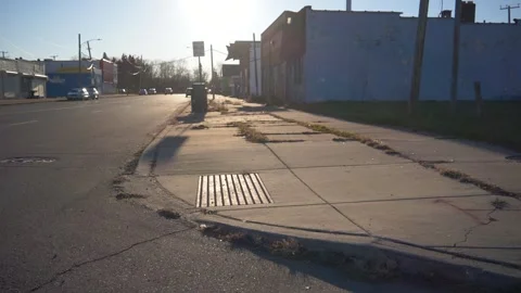 Slow motion Dolly shot orbiting curb on the East side of Detroit during Stock Footage 243788822