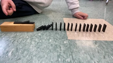 Slow motion dominos falling on floor Stock Footage 245210735