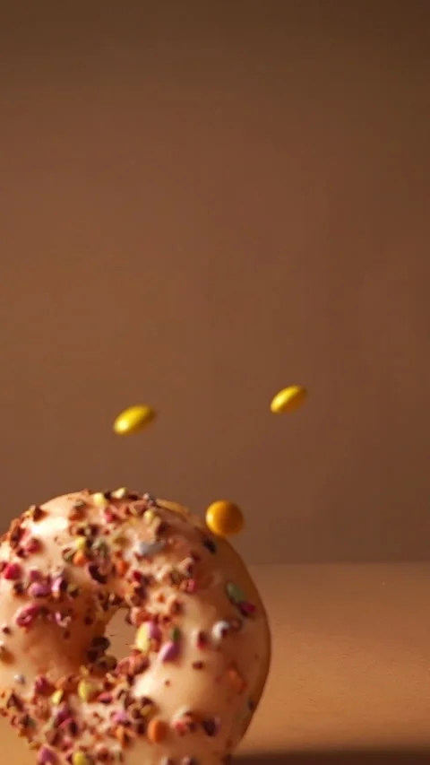 Slow Motion Donuts with Cookie Crumbs and Colorful Candy Falling Stock Footage 331232798