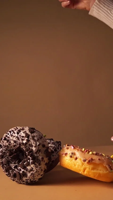 Slow Motion Donuts Falling with Cookie Crumbs and Candy Pieces Stock Footage 331232726