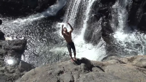 Slow Motion Double Back Flip Cliff Jump into Waterfall Stock Footage 87723816