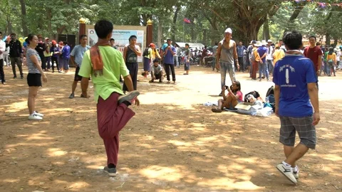 Slow motion double kick to a shuttlecock during a jianzi game in Siem Reap-Dan Stock Footage 119056958