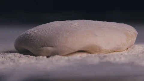 Slow motion dough falling into flour. Stock Footage 112595609