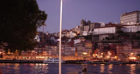Slow motion of douro river going through porto at night with lights reflecting Stock Footage 155255413
