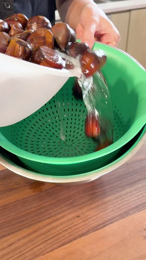 Slow Motion Draining Soaked Chestnuts in Colander, Preparing for Cooking, 4K Stock Footage 332573508