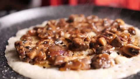 Slow motion dramatic closeup mushroom and onion gravy on top of dosa Stock Footage 136653327