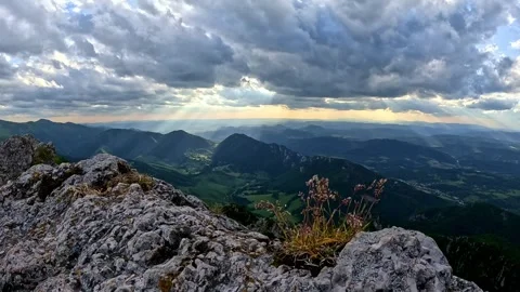 Slow-motion of dramatic clouds and wind-blown grass on a rocky mountain peak Stock-Footage 316144744