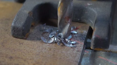 Slow motion drill bit processes metal workpiece on drilling machine Stock Footage 117932783