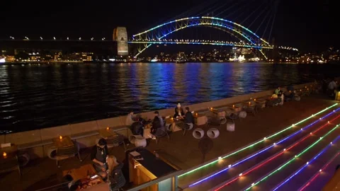 Slow motion drinks by Sydney harbour during Vivid light festival 4K Stock Footage 165707079