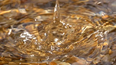 Slow motion of dripping on shallow pure water with brown pebble bottom close up. Stock Footage 98096388