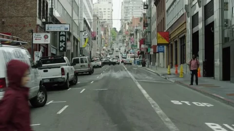 Slow motion drive by shot looking down San Francisco street Stock Footage 145886452