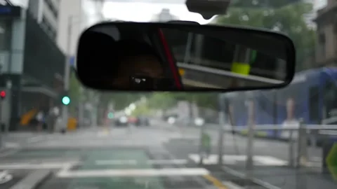 Slow motion driving inside car female reflection in rear view mirror moody Stock Footage 155844771