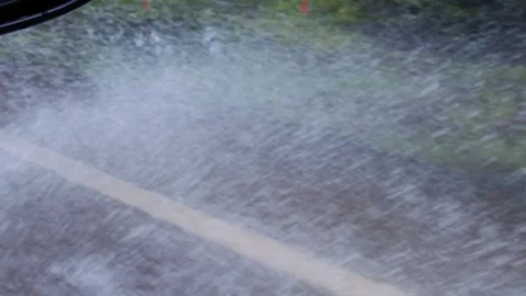 Slow motion driving through flooded road Stock Footage 79714619