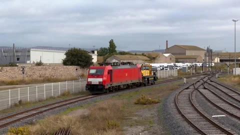 Slow motion Drone Aerial Red Freight Train Loading Industrial Rail Yard Stock Footage 338371530