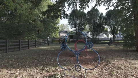 Slow motion drone approach toward blue dog agility jump hoops Stock Footage 346731970
