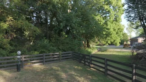 Slow motion drone drift over dog park at golden hour with long shadows Stock Footage 346670597