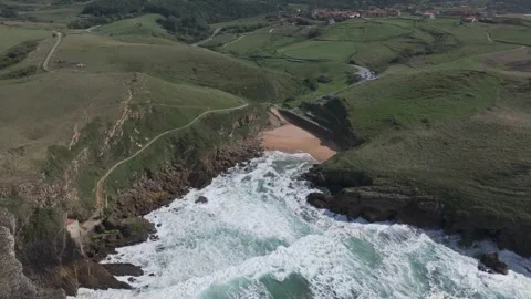 Slow-motion drone flight over Santa Justa Beach and coastal cliffs in Cantabria Stock Footage 321805268