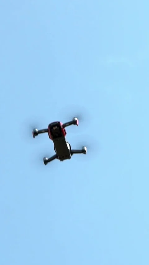Slow motion of drone flying overhead in blue sky. Unmanned helicopter flight Stock Footage 317718856