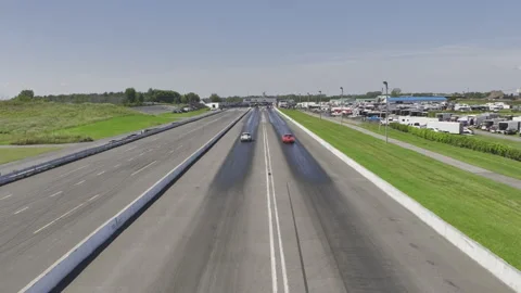 Slow motion drone pull-back view over cars competing on race track 스톡 동영상 231348415