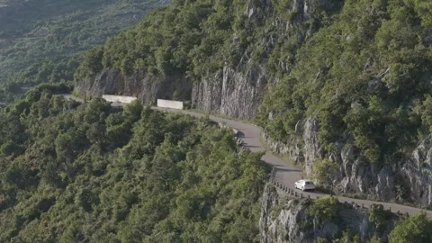 Slow Motion Drone Shot of Car Driving on Narrow Mountain Road in Montenegro Stock Footage 310335512