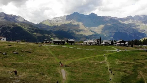 Slow Motion Drone Shot of Mountain Walking Path with People Walking in Distance Stock Footage 197602134