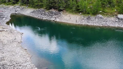 Slow Motion Drone Shot of Mountain Lake with Pebble Thrown on Water Stock Footage 197602773