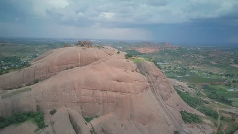 Slow motion drone shot of an old built structure on the huge rock formation Stock Footage 122482028