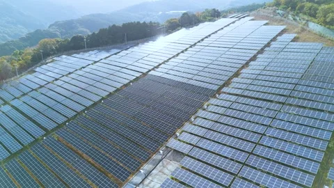Slow Motion Drone Shot Tilting Up to Reveal Vast Solar Array Station Stock Footage 336594507