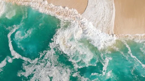 Slow Motion Drone Video Looking down on Clear Turquoise Waves Washing on Beach 動画素材 123314692