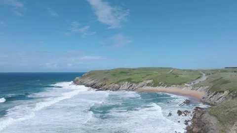 Slow-motion drone view of Tagle Beach and the ruins of the 14th-century San Stock Footage 321806357