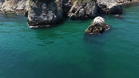 Slow Motion Drone View of Waves Crashing Around Coastal Sea Rocks Stock Footage 341530617