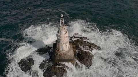 Slow Motion Drone Of Waves Crashing Into Lighthouse And Seagull Taking Off Video stock 96238224