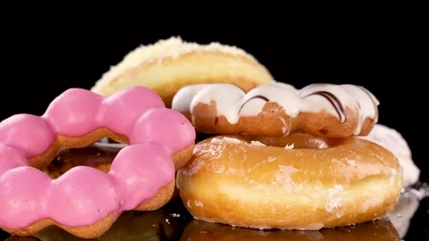 Slow Motion Drop of Assorted Glazed and Iced Donuts Stock Footage 314928531