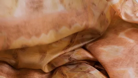 Slow motion drop of a luxury silk fabric with beige and brown patterns. Stock Footage 337404803