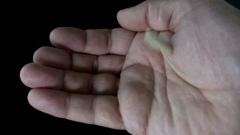 Slow motion drop of pills on a man’s palm Stock Footage 113355034