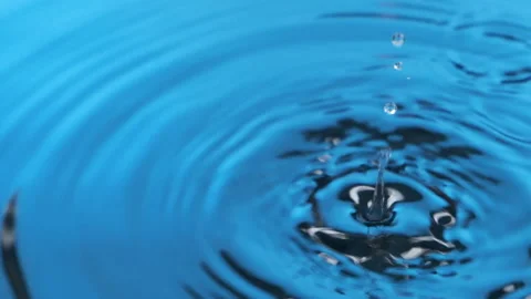 Slow motion. A drop of water falls into blue water. Panorama Stock Footage 171102486