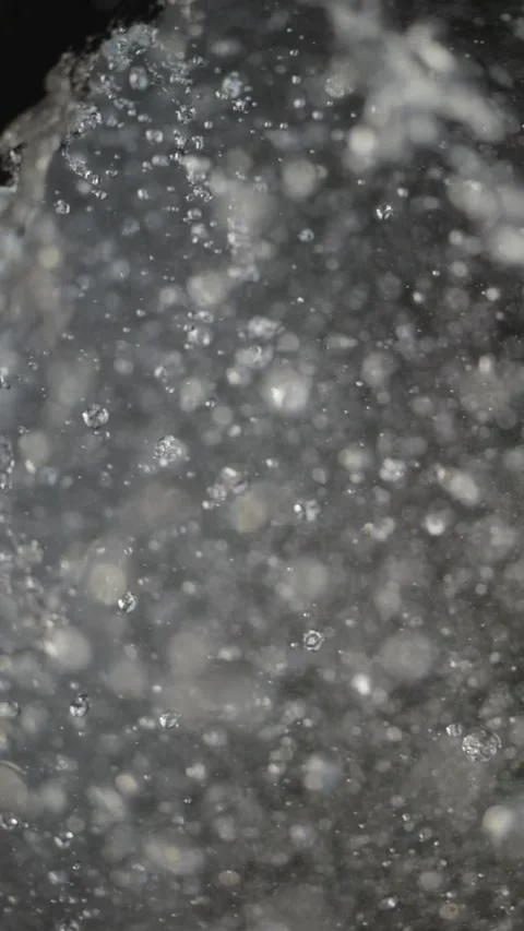 Slow-motion droplets fall from rocks, each crystal-clear drop visible. In t.. Stock Footage 291094012