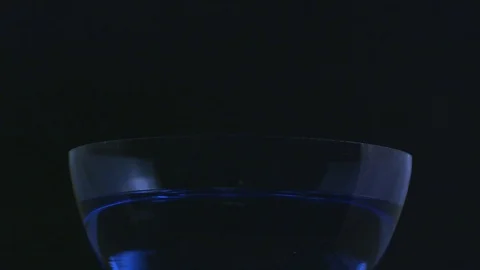 Slow motion dropping dry ice into a blue bowl of water Stock Footage 70705752