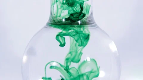 Slow Motion: Dropping green liquid into Beaker Stock Footage 111307389
