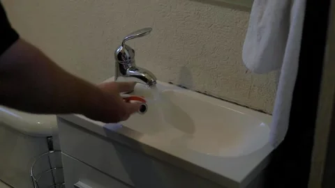 Slow Motion Dropping Toothbrush In Sink, Traveler's Diarrhea Stock Footage 154640314
