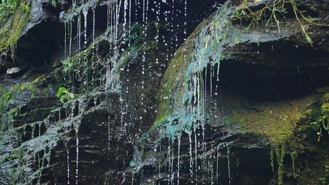 Slow motion of Drops falling from a rock Stockbeeldmateriaal 127219356