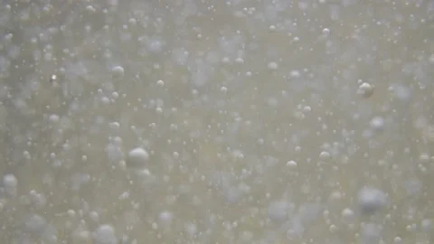 Slow motion drops of one liquid float in a clear liquid Stock Footage 131003991