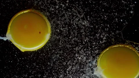 Slow motion of drops of sugar in to a broken chicken egg Video stock 156798171
