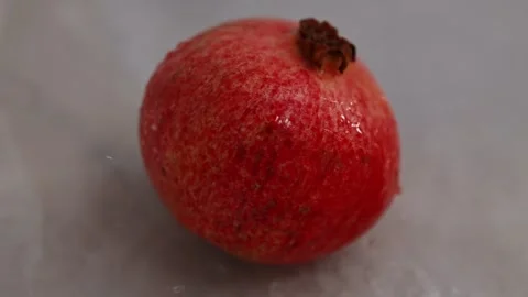 Slow motion drops of water dripping on pomegranate Stock Footage 227697277