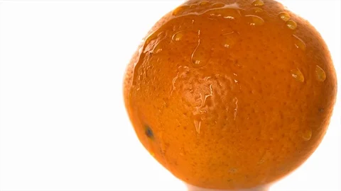 Slow motion. Drops of water fall from a juicy citrus peel. UHD 4K footage  Stock Footage 115100570