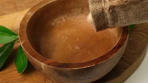 Slow motion dry cashew falling into wooden bowl on board. Close up. Stock Footage 124746653