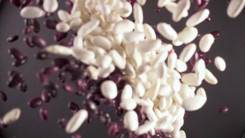 Slow motion dry ingredient groat falls from under the camera Video stock 90901953