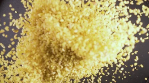Slow motion dry ingredient groat falls from under the camera Stock Footage 90902540