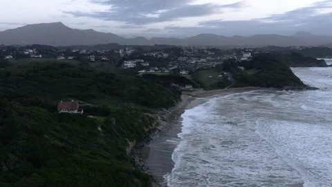 Slow-motion dusk aerial view of beautiful French surf spot Stock Footage 112706264