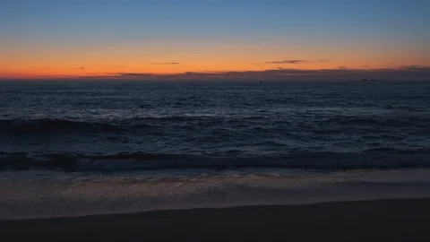 Slow motion dusk over ocean. Beautiful vivid orange blue gradient sky Stock Footage 115758749